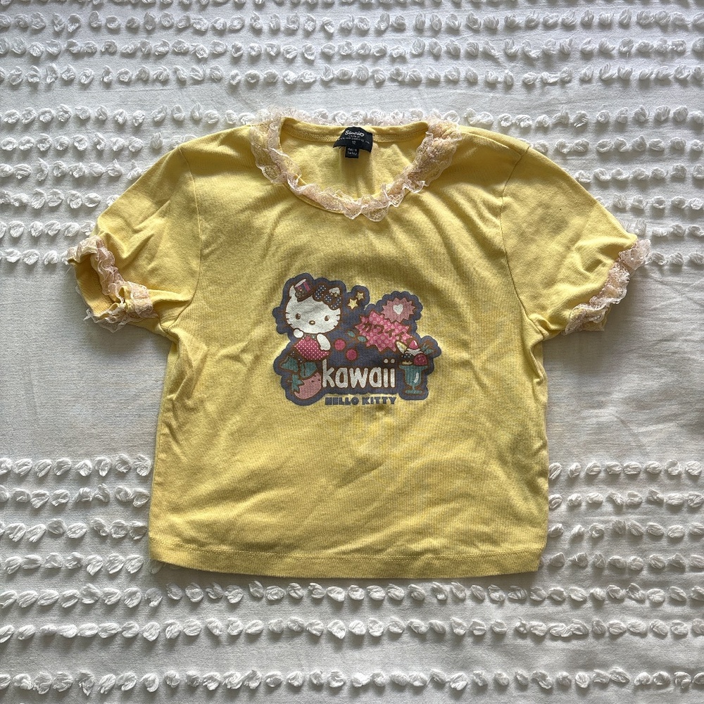 Sanrio, Hello Kitty yellow baby tee with white lace trim and kawaii design front